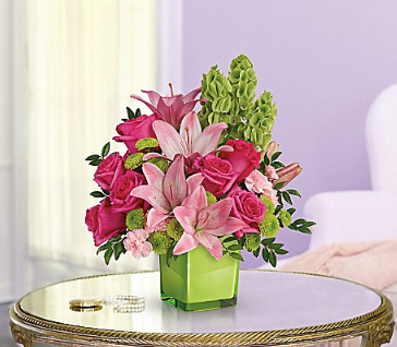 Pink lilies and hot pink roses in green vase
