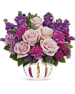 Pink and purple flowers fill the birthday container