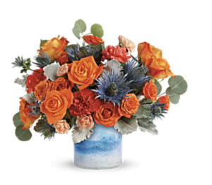 orange and blue flowers exploded in a blue vase