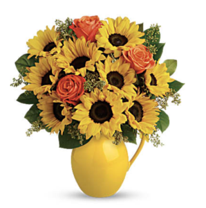 Yellow sunflowers and orange roses fill a yellow vase